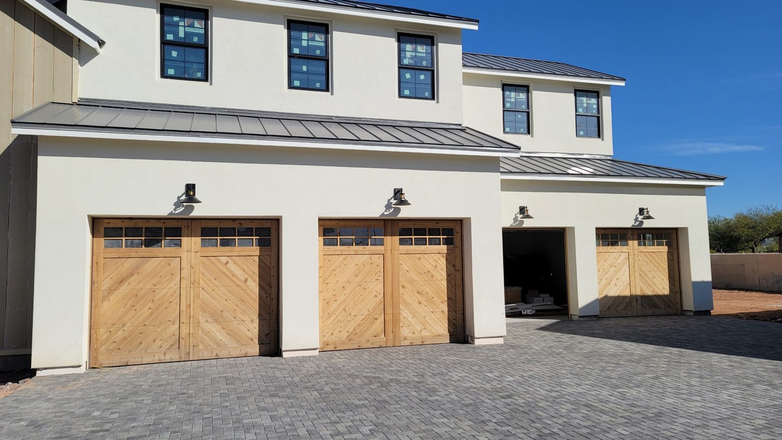 Three cedar clad herringbone garage doors on a modern farmhouse